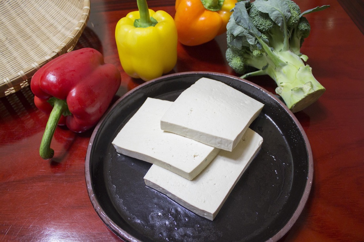 A healthy bowl containing tofu, leafy greens, and almonds rich in magnesium